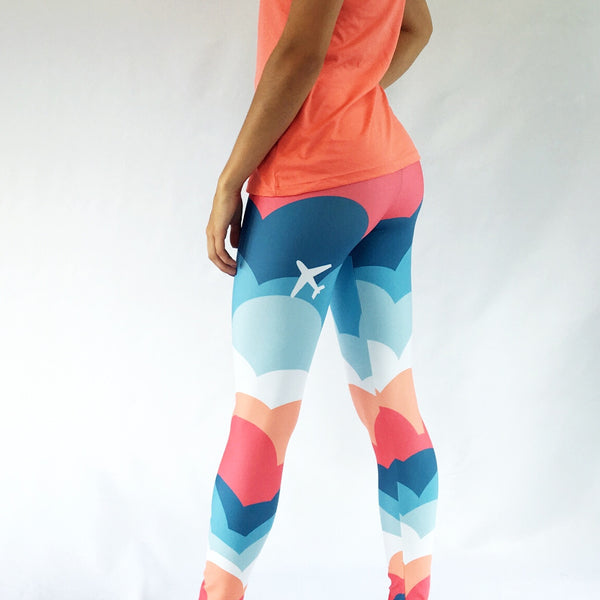One Plane Jane signature cloud leggings. Fun blue, orange and coral design with an airplane on the back side of right leg. Cute, comfy and fun.  Perfect for aviators or anyone that loves to travel. 