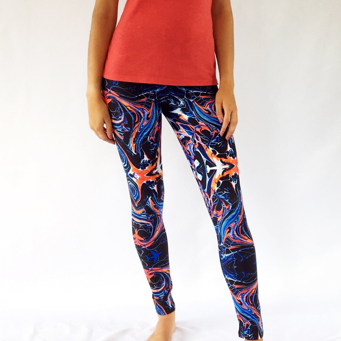 One Plane Jane Womens leggings. Mystic pattern - black with red, orange, and blue kaleidoscope with strategically placed airplanes. Great for flying, travel, or just for fun. 