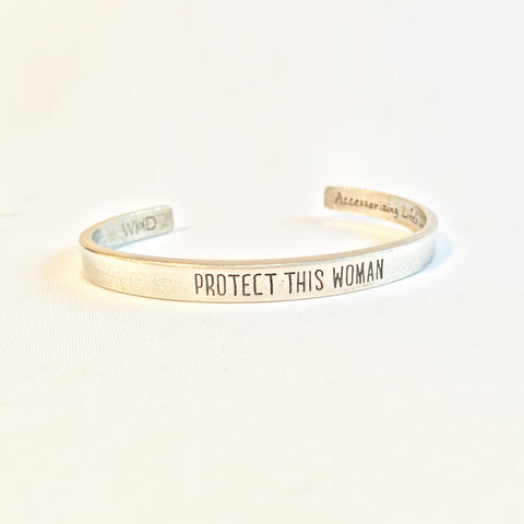 Protect This Woman Pewter adjustable cuff bracelet front view.  "Protect This Woman" displayed on face of bracelet.